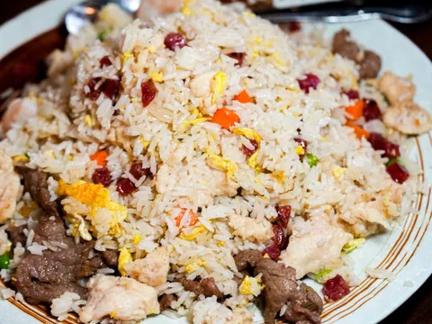 Beijing (川味居)'s signature fried rice studded with char siu, egg, shrimp, chicken, and beef, served on a plate in Salt Lake City's Sugar House