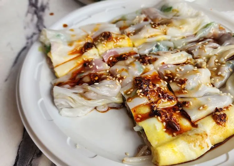 Steamed rice rolls (cheung fun) drizzled with sweet soy and chili oil and topped with sesame seeds at Joe's Steam Rice Roll, Flushing