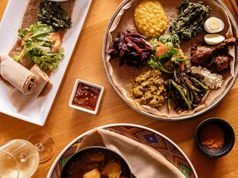 Ethiopian combination platters on injera with stews, greens and salads, plus a spice tray, at Demera in Chicago