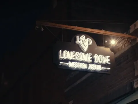 Illuminated Lonesome Dove Western Bistro sign on the Fort Worth exterior